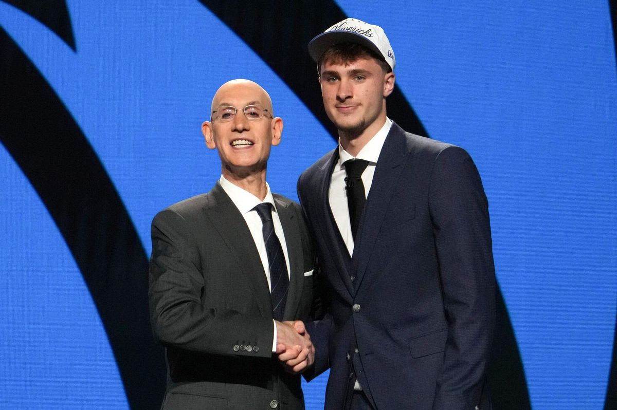TOPSHOT - US basketball player Cooper Flagg (R) shakes hands with NBA Commissioner Adam Silver after being selected first overall by the Dallas Mavericks during the opening round of the 2025 NBA Draft at Barclays Center in Brooklyn, New York, on June 25, 2025. Versatile US college teen star Cooper Flagg was selected first overall in the NBA draft on June 25 by the Dallas Mavericks, where he'll join a star-laden team already touted as a playoff threat next season. Flagg, a consensus pick as the top US college player as a freshman at Duke University last season, is the second-youngest player taken first overall. (Photo by TIMOTHY A. CLARY / AFP)