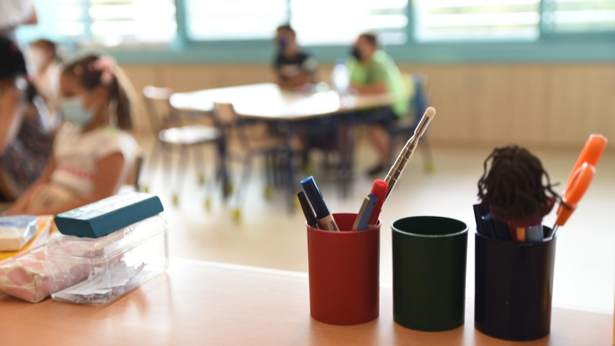 Archivo - Recipientes llenos de lápices en un aula.