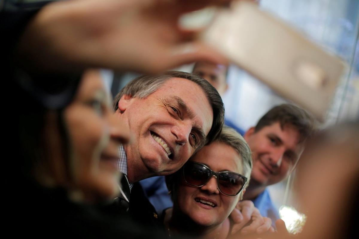 FILE PHOTO  Presidential candidate Jair Bolsonaro poses for picture at the National Congress in Brasilia  Brazil September 4  2018  REUTERS Adriano Machado File Photo