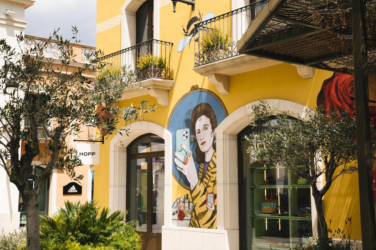 Gala, bajo la mirada de la joven pintora Carla Fuentes, en una de las obras que adornan las fachadas de La Roca Village.