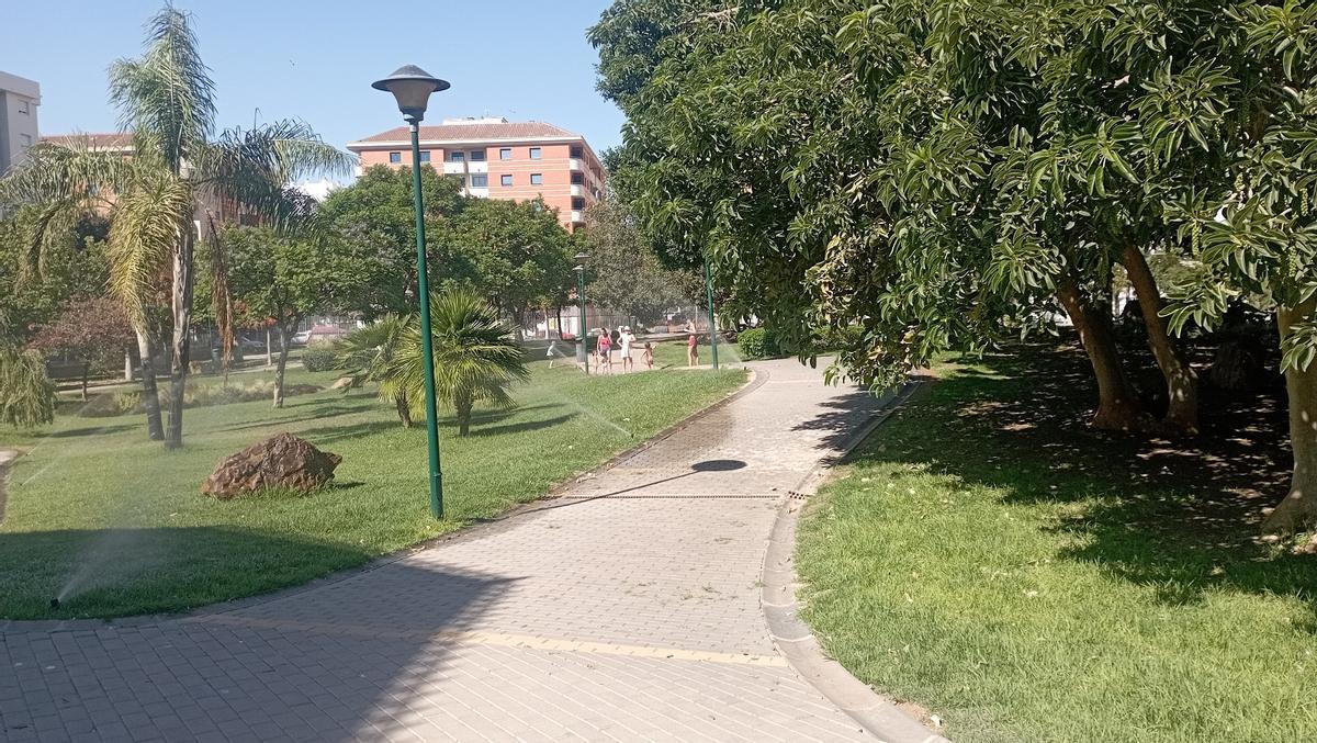 Varios chiquillos combatían el lunes el terral en el Parque de Huelin, gracias a los aspersores en marcha.