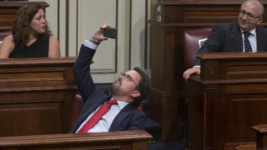 El líder del PP Asier Antona hace una foto con su móvil desde su escaño durante el pleno celebrado esta semana en el Parlamento.