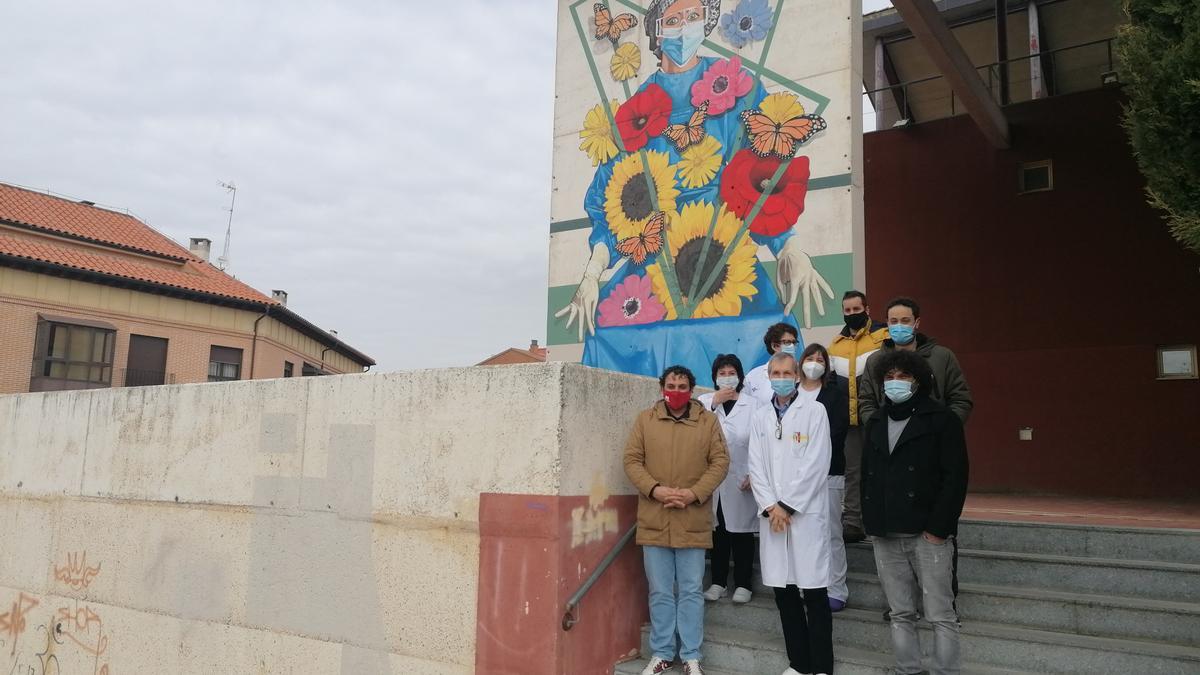 Adeva posa con autoridades y sanitarios junto al mural creado en el centro de salud de Toro