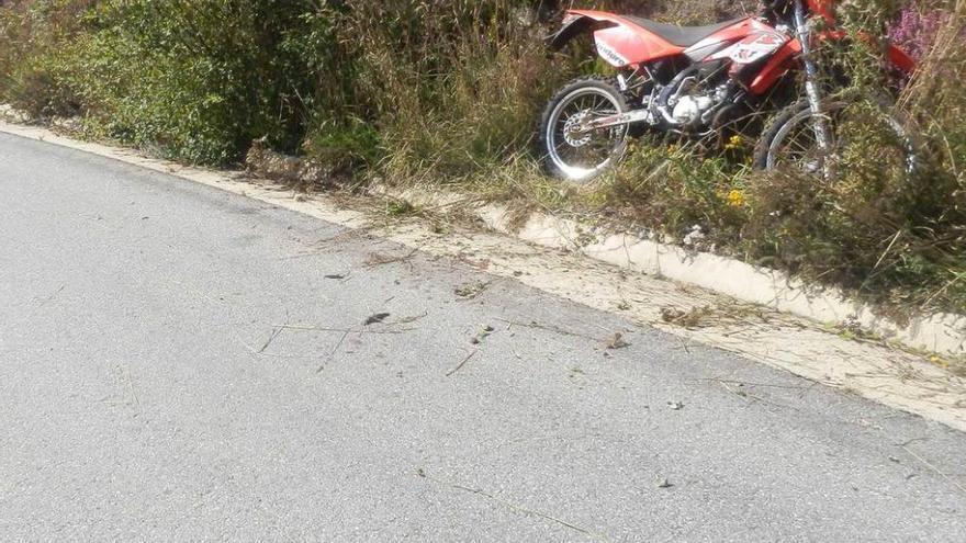 La moto del fallecido en Tamón. Al fondo, agentes de la Guardia Civil.