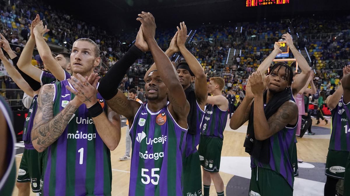 Los jugadores del Unicaja celebran con la 'marea verde' la victoria ante el Joventut.