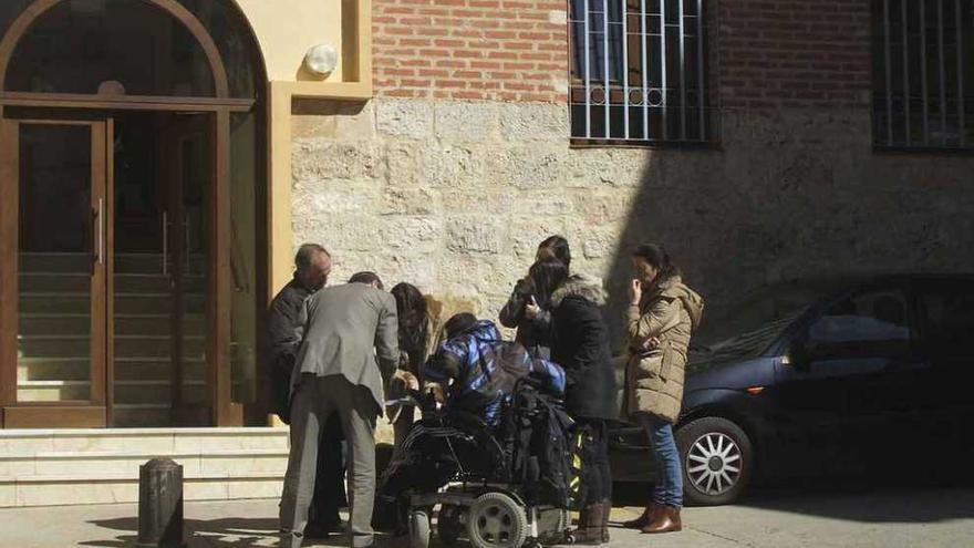 El joven en silla de ruedas presta declaración en la plaza del Concejo en la que se ubica el juzgado. Foto