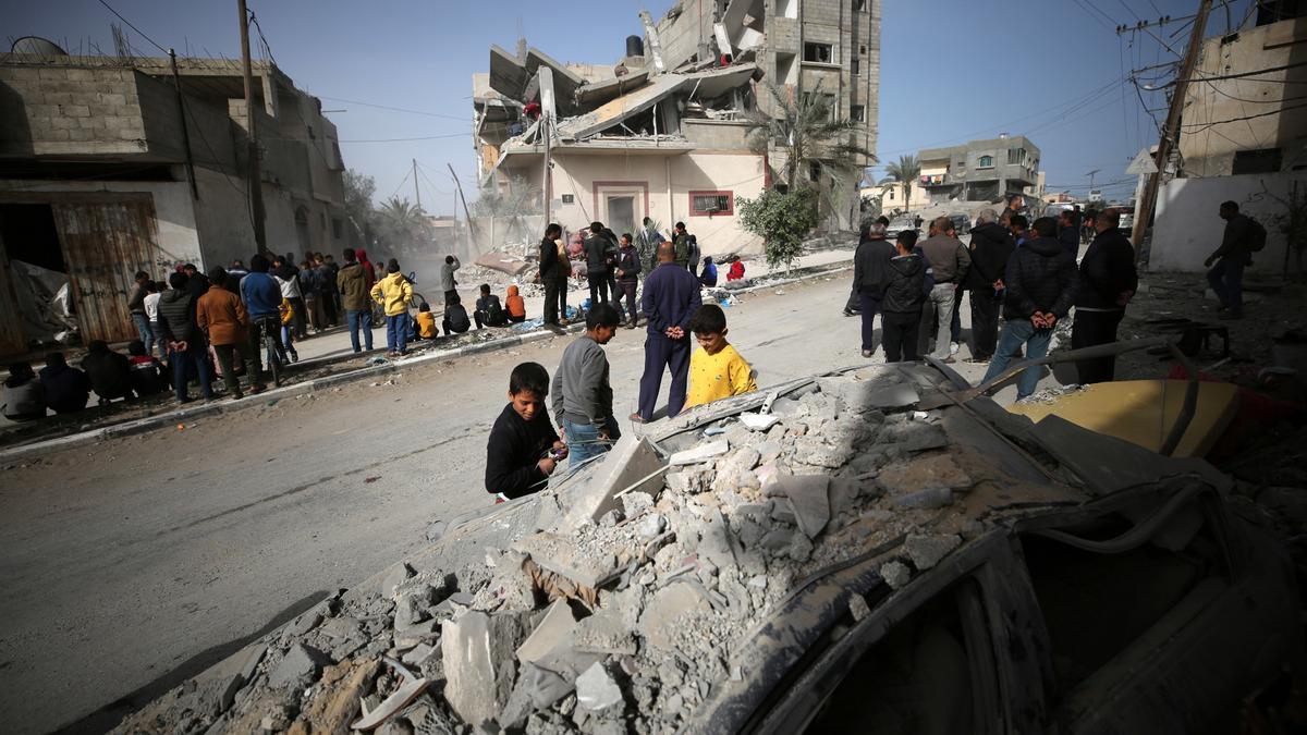 GAZA, March 27, 2024  -- People gather around a destroyed building after an Israeli airstrike in the southern Gaza Strip city of Rafah, on March 27, 2024. The Palestinian death toll from ongoing Israeli attacks has risen to 32,490, the Hamas-run Health Mi