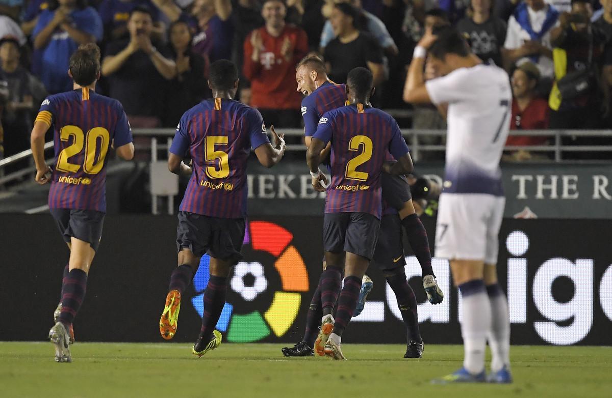 Barcelona midfielder Arthur, center, celebrates his goal with teammates midfielder Sergi Roberto, left, midfielder Marlon Santos, second from left, and defender Nelson Semedo, second from right, as Tottenham forward Son Heung-Min wipes his head during the first half of an International Champions Cup tournament soccer match Saturday, July 28, 2018, in Pasadena, Calif. (AP Photo/Mark J. Terrill) Barcelona midfielder Arthur, center, celebrates his goal with teammates midfielder Sergi Roberto, left, midfielder Marlon Santos, second from left, and defender Nelson Semedo, second from right, as Tottenham forward Son Heung-Min wipes his head during the first half of an International Champions Cup tournament soccer match Saturday, July 28, 2018, in Pasadena, Calif. (AP Photo/Mark J. Terrill)