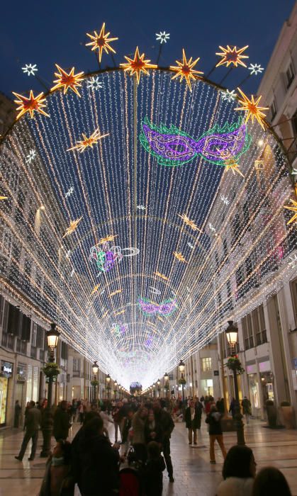 La principal calle del centro de Málaga ya luce los motivos carnavalescos, máscaras y antifaces, con motivo de la Fiesta del Invierno Cálido de la ciudad