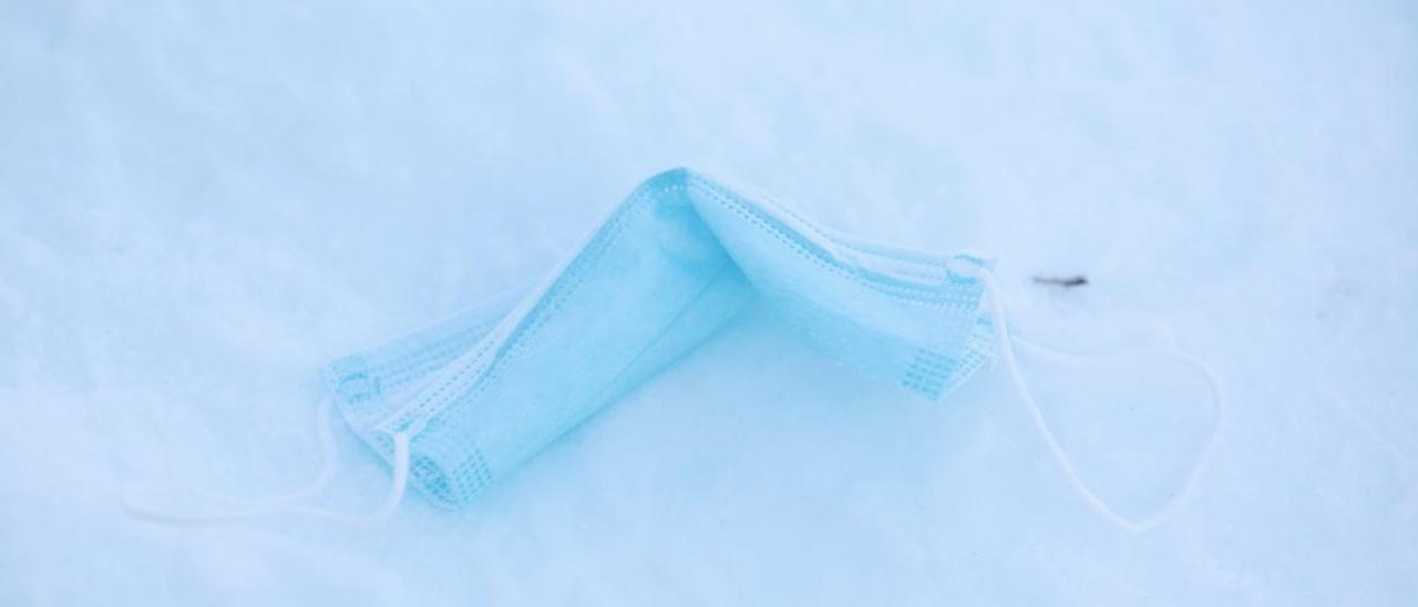 Una mascarilla tirada en la nieve.