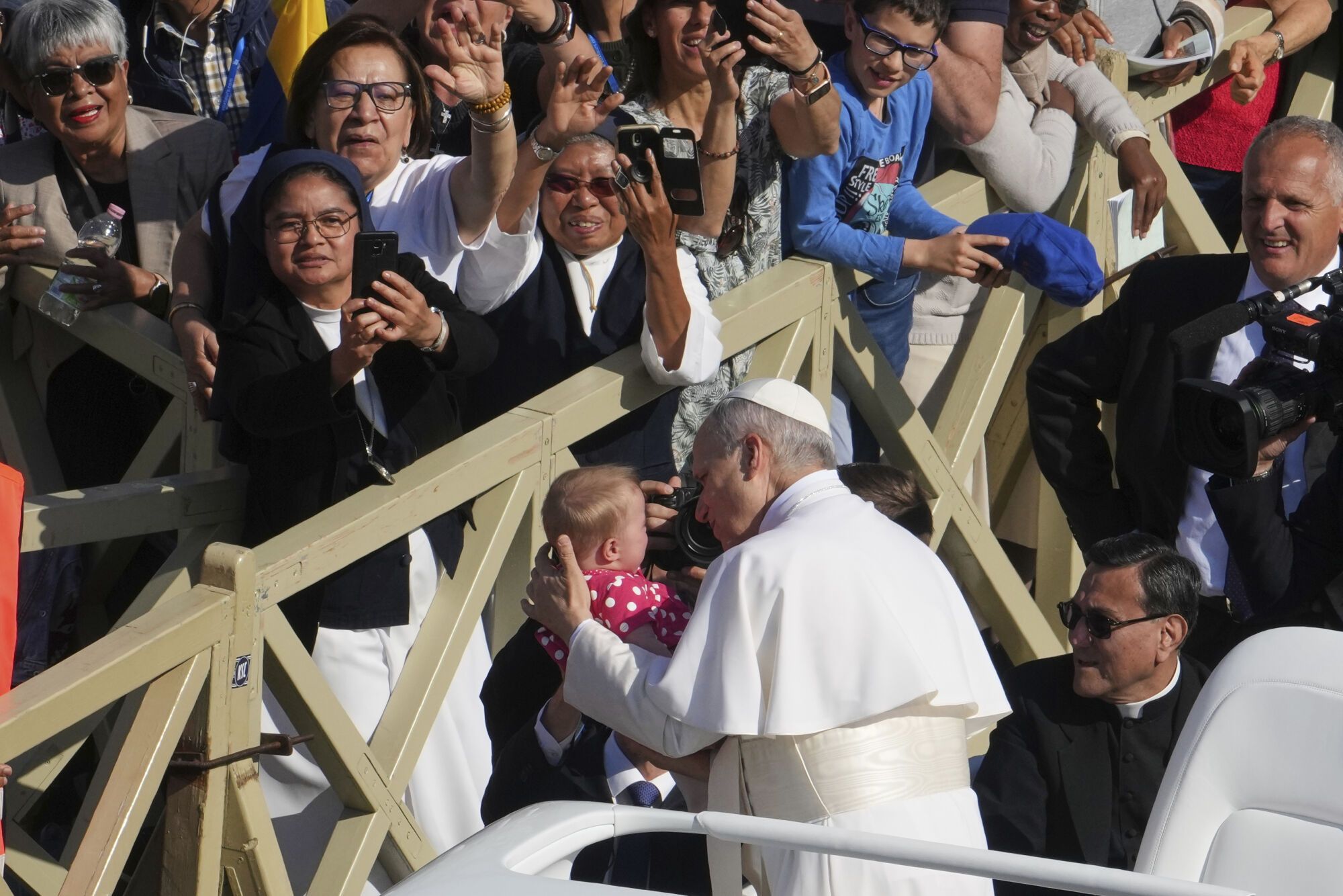 Pope Leo XIV is handed a baby as he tours St. Peter's Square at the Vatican prior to the inaugural Mass of his pontificate, Sunday, May 18, 2025. (AP Photo/Domenico Stinellis) Associated Press/LaPresse. EDITORIAL USE ONLY/ONLY ITALY AND SPAIN