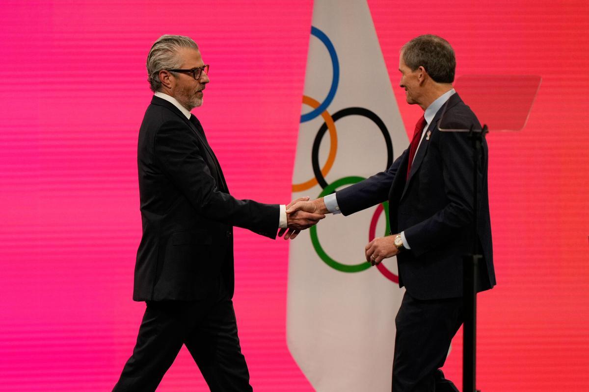 Casey Wasserman, Chairman of the Los Angeles Organizing Committee for the 2028 Olympic and Paralympic Games walks on the stage,during an IOC meeting ahead of the 2026 Winter Olympics, in Milan, Italy, Tuesday, Feb. 3, 2026. (AP Photo/Luca Bruno)