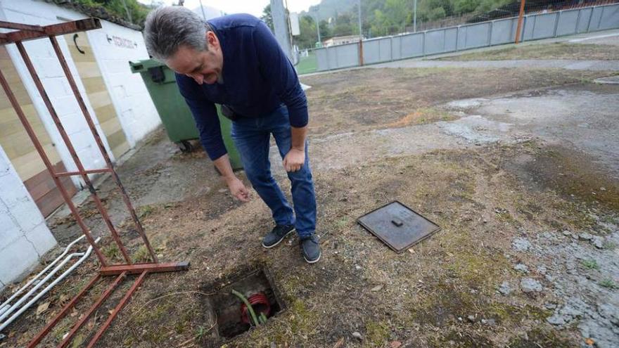 Juan Carlos Álvarez muestra la arqueta de la que robaron el cable en el campo de fútbol de Turón.