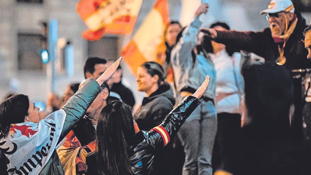 Manifestación neonazi en Madrid, en una imagen de archivo, y, en el recuadro superior, una de las octavillas repartidas el pasado sábado en el centro de Santiago. | Diego Radamés / Cedida