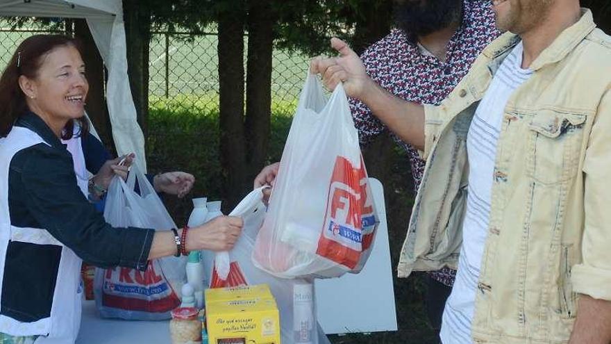 Una voluntaria recogiendo alimentos en el puesto del Surfing. // R.V.