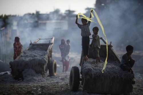 Children play on waste products to be processed at a tannery at Hazaribagh, along the polluted Buriganga river, in Dhaka