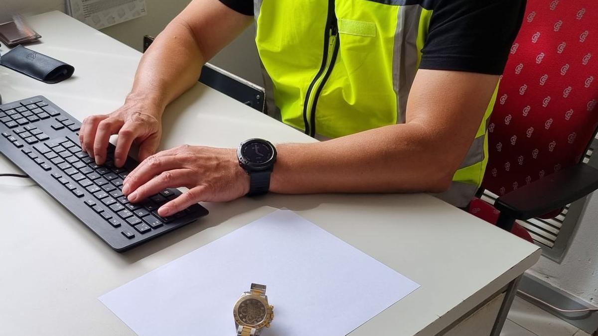 Un policía, con el reloj recuperado.