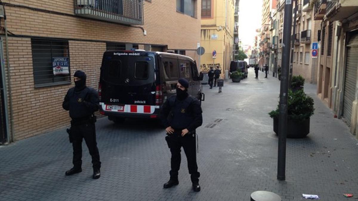 Agentes de los Mossos, frente a la sede del Ateneu Llibertari de Sants, en la calle Maria Victòria de Barcelona, este miércoles.