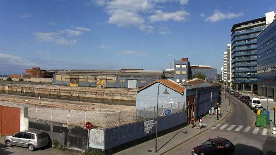 Instalaciones de Naval Gijón frente a los edificios de Poniente.