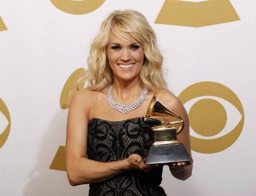 Carrie Underwood poses with her award for Best Country Solo Performance backstage at the 55th annual Grammy Awards in Los Angeles