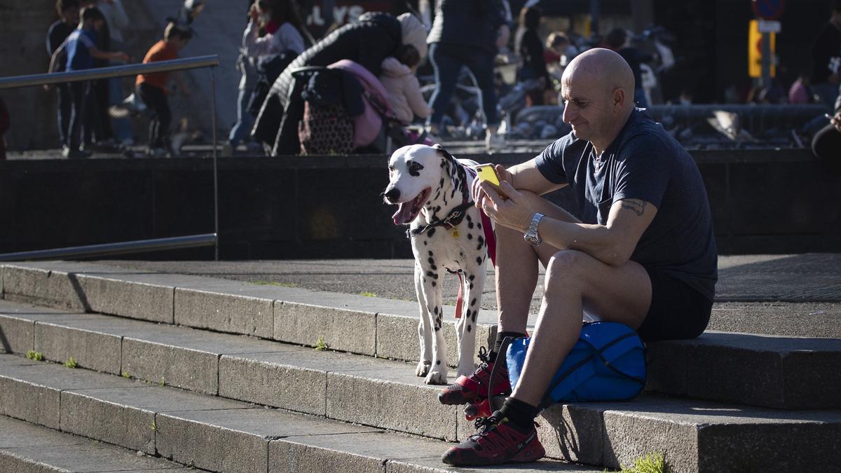 Gente aprovechan este día de calor en invierno para pasear en manga corta en la plaça Catalunya