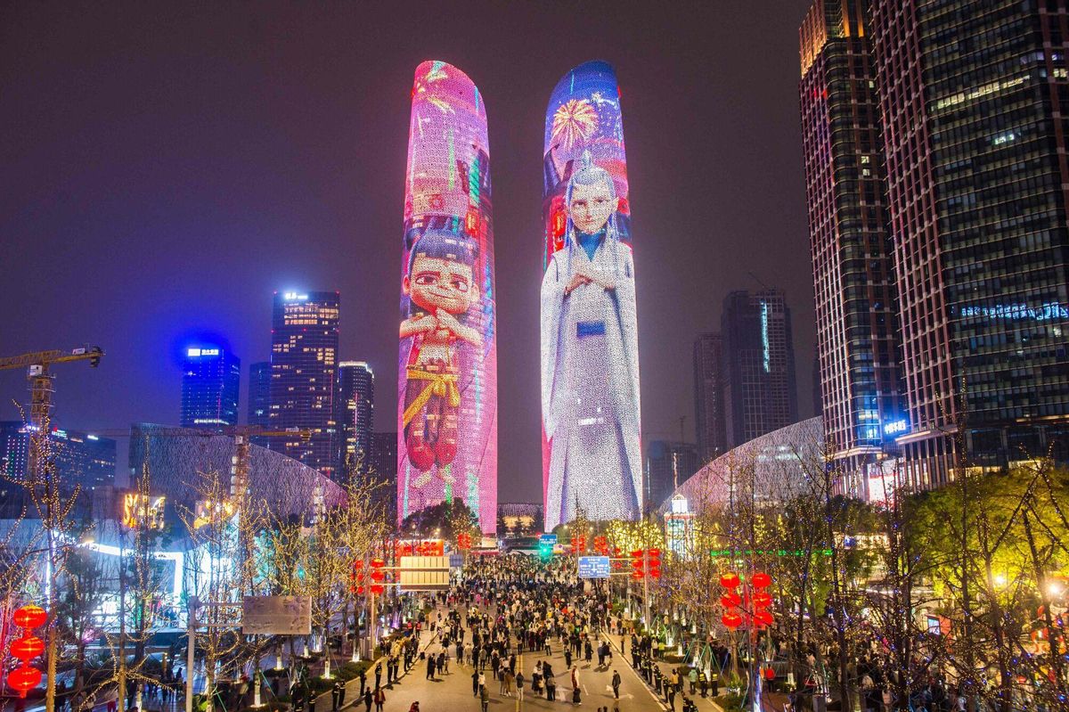 Buildings are lit up with characters from the movie “Ne Zha 2” in Chengdu, in China’s southwest Sichuan province on February 12, 2025. Animated Chinese blockbuster "Ne Zha 2", based on traditional mythology, has smashed multiple box office records on its way to becoming the country's most successful movie ever. (Photo by AFP) / China OUT. China OUT
