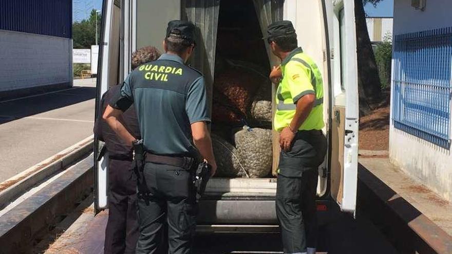 Agentes de la Guardia Civil, supervisando el furgón. // DBM