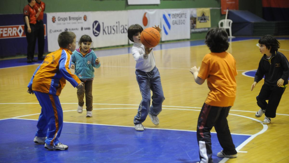 Niños juegan un partido de baloncesto.