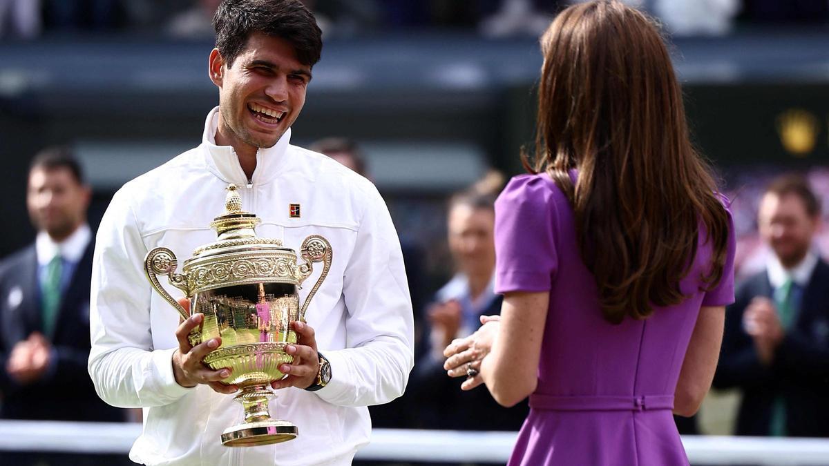 Alcaraz recibe el trofeo de campeón de Wimbledon junto a Kate Middleton.