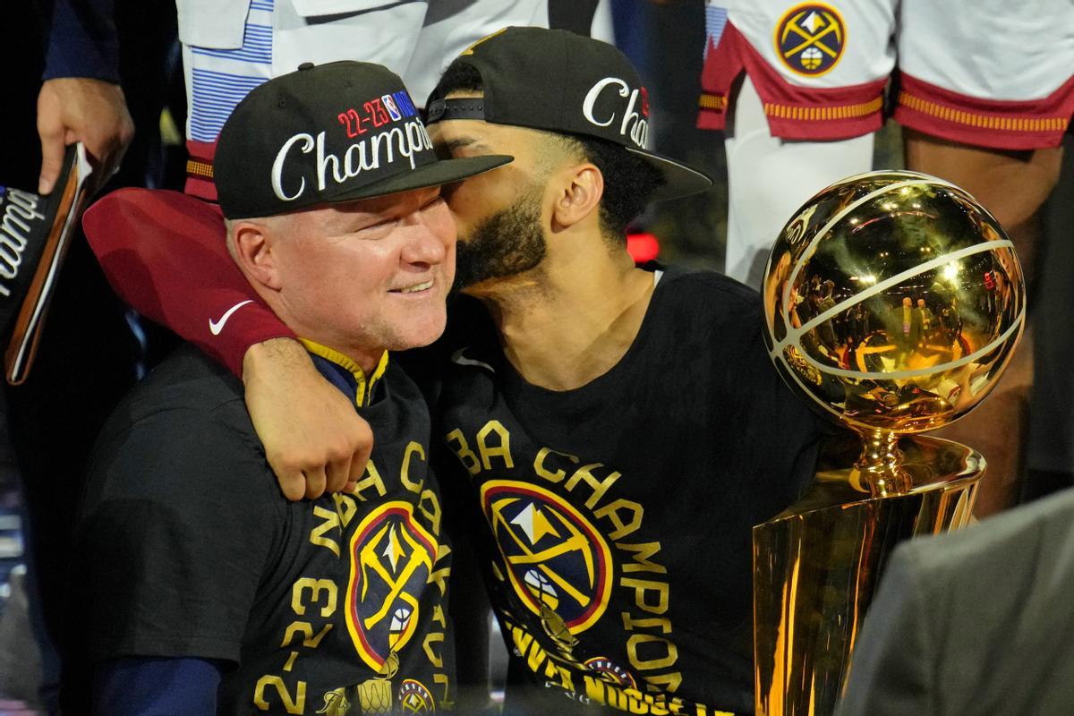 El técnico Mike Malone recibe un beso de Murray en la entrega de trofeos