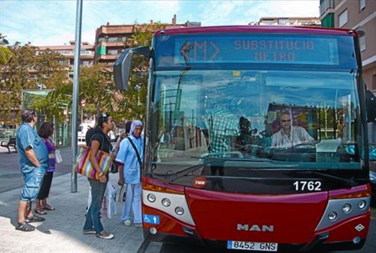 Usuaris de les línies L-9 i L-10 pugen al bus alternatiu a l’estació Onze de Setembre, ahir.
