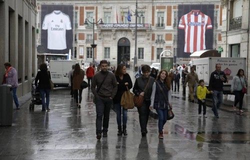 Giant posters of Real Madrid and Atletico Madrid jerseys hang on the facade of Madrid's regional government building at Puerta del Sol in Madrid