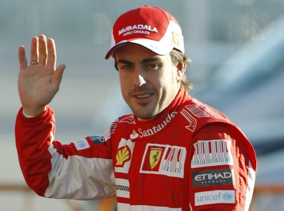 Ferrari Formula One driver Alonso of Spain waves ...