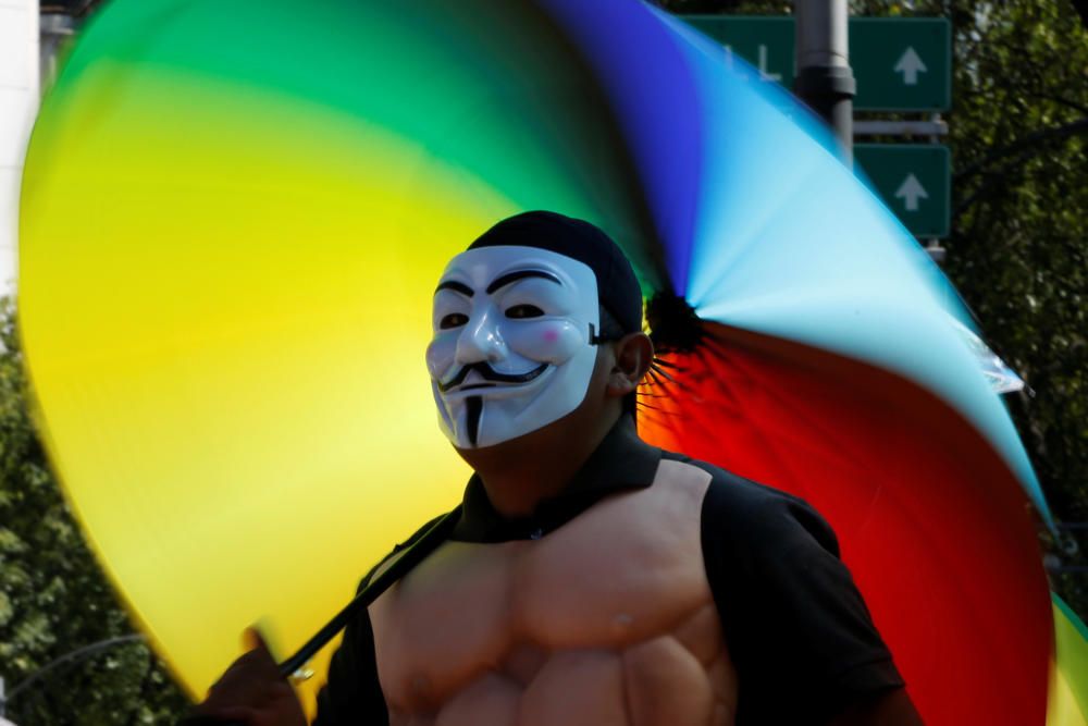 An umbrella vendor is seen near a protest ...