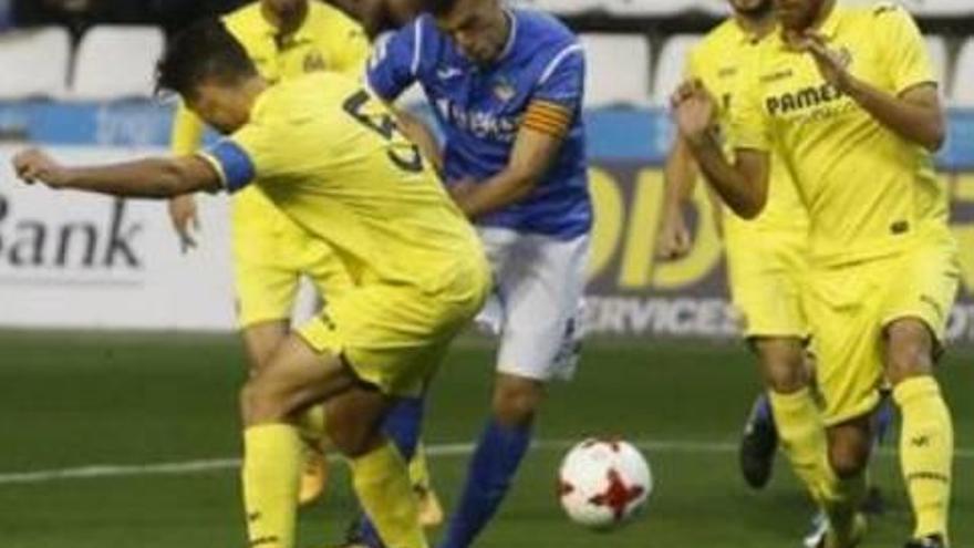 Dos jugadores del Villarreal B presionan al capitán del Lleida.