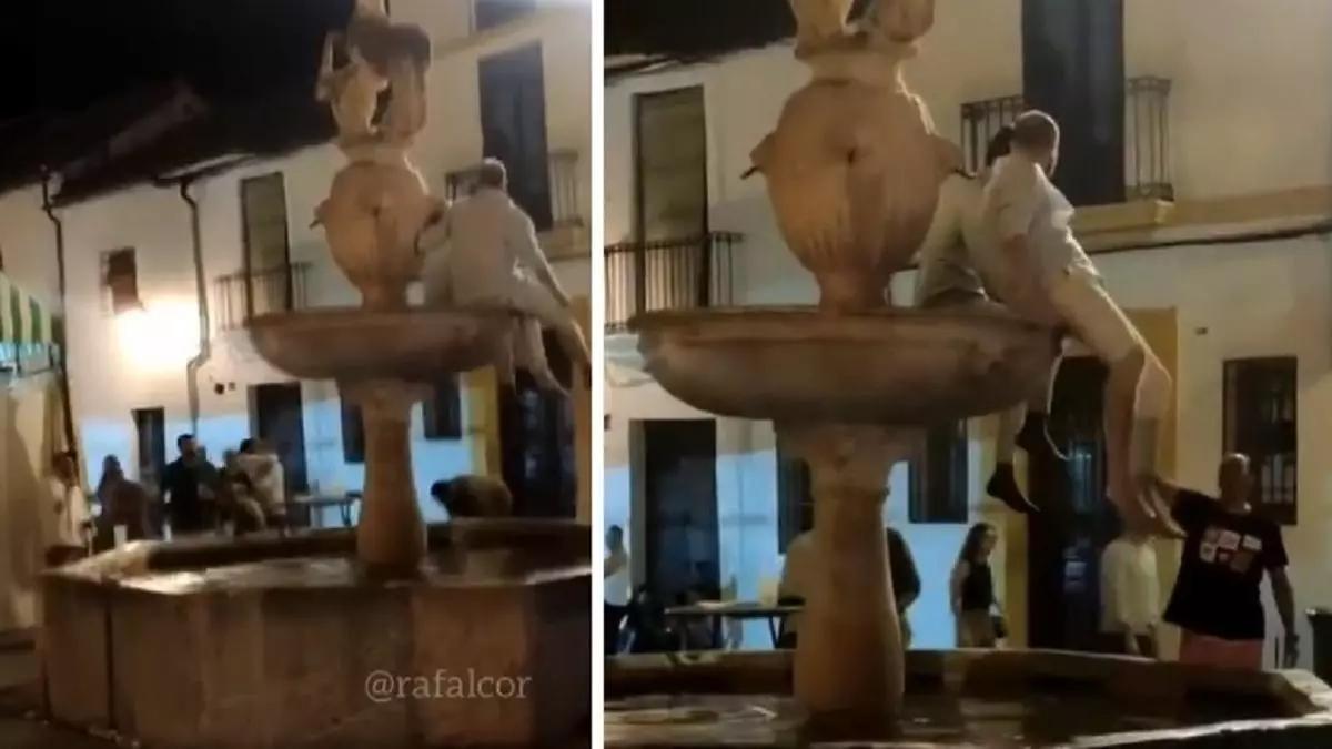 Dos jóvenes subidos en la fuente de la Plaza del Potro.