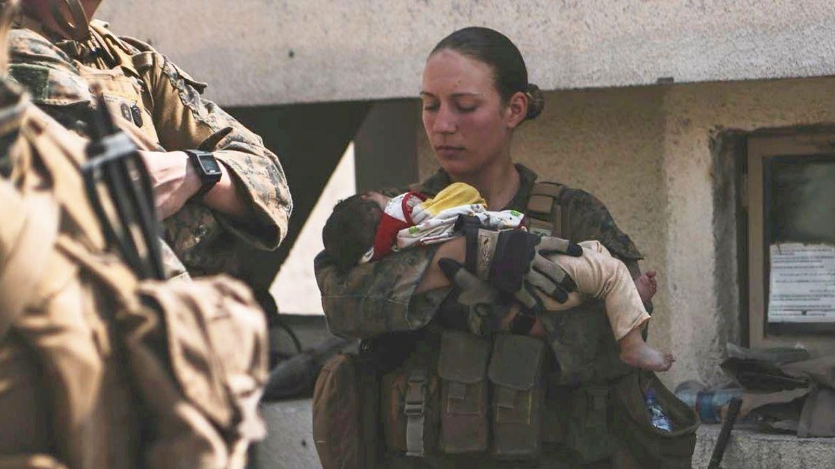 FILE PHOTO: U.S. Marine Sgt Nicole Gee stands while holding an infant during an evacuation at Hamid Karzai International Airport, Kabul FILE PHOTO: U.S. Marine Sgt Nicole Gee stands while holding an infant during an evacuation at Hamid Karzai International Airport, Kabul