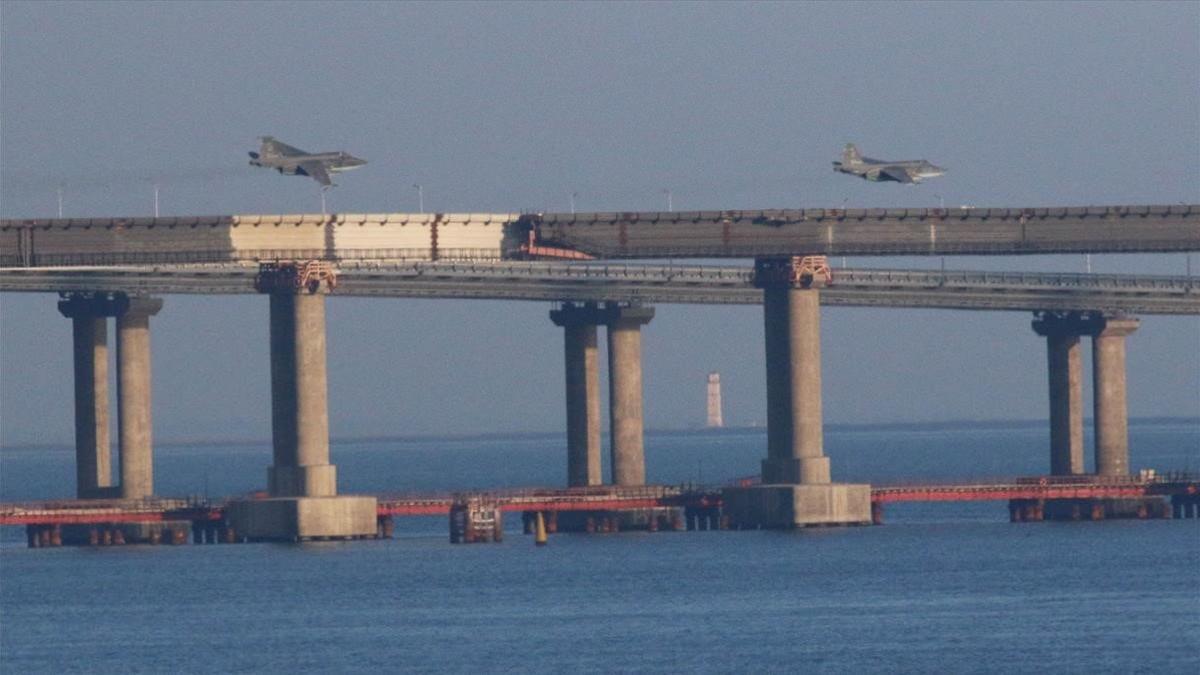 Dos aviones de guerra rusos sobrevuelan el puente que une Rusia con Crimea en el mar de Azov.