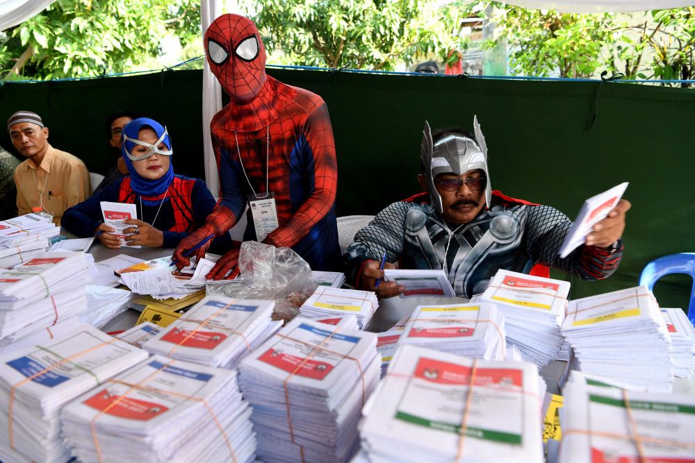 Election officials wearing superhero costumes ...