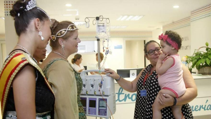 Una niña recibe la visita de las festeras de Moros y Cristianos en el hospital Virgen de la Arrixaca.