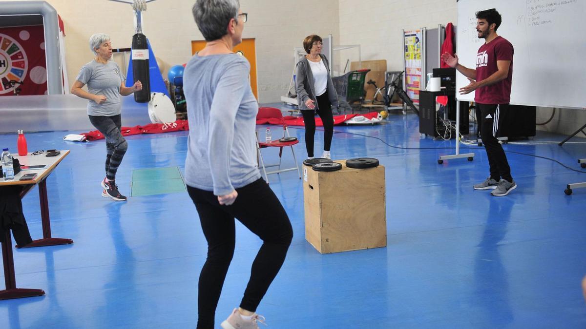 Un grupo de personas mayores hace ejercicios físicos en el Centro de Investigación del Deporte tras seguir las indicaciones de un monitor de la UMH.