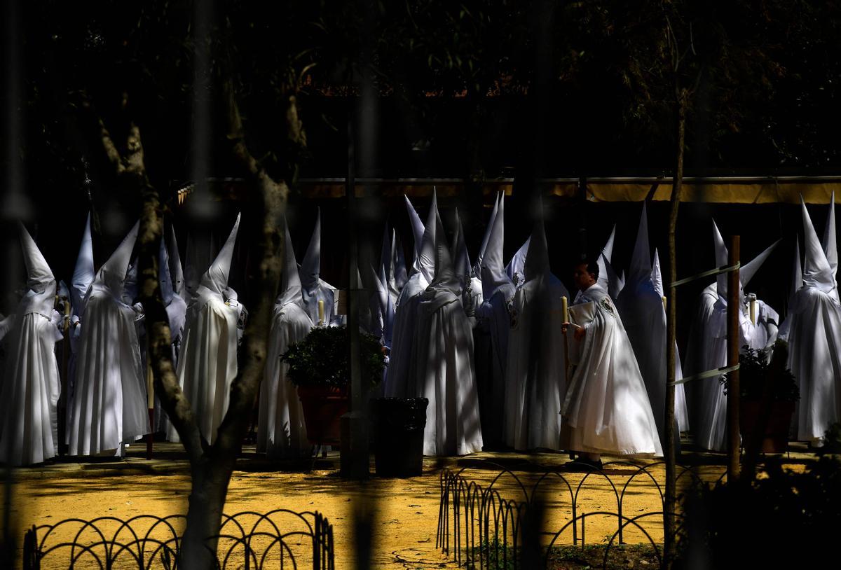 Penitentes de la hermandad de La Paz participan en la procesión del Domingo de Ramos en Sevilla