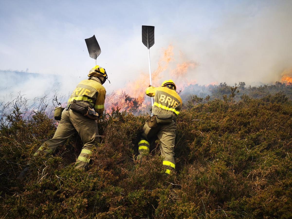 Dos bomberos forestales de la Brif de Tineo en la incendio de Lavadoria.