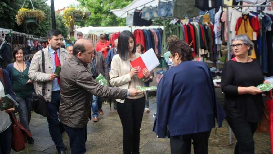 Leiceaga, centro, entrega ayer propaganda electoral en un mercado de Salceda de Caselas. // FDV