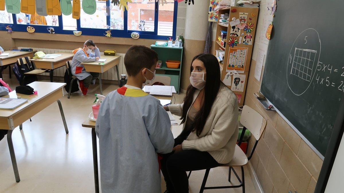 Una profesora haciendo uso de la mascarilla transparente en clase.