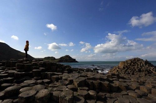 A woman poses for a picture on the rocks at the Giant's Causeway situated on the north coast of Northern Ireland.