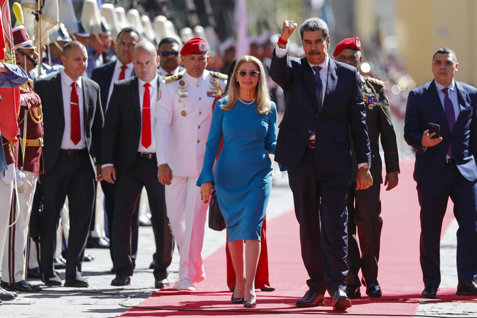 Venezuelan President Nicolas Maduro and his wife Cilia Flores arrive at the National Assembly for his swear-in ceremony for a third term in Caracas, Venezuela, Friday, Jan. 10, 2025. (AP Photo/Cristian Hernandez)