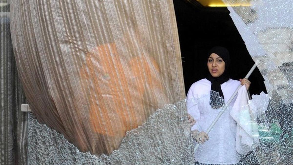 Una empleada del hotel de la cadena española Barceló en El Cairo limpia los cristales tras el ataque.