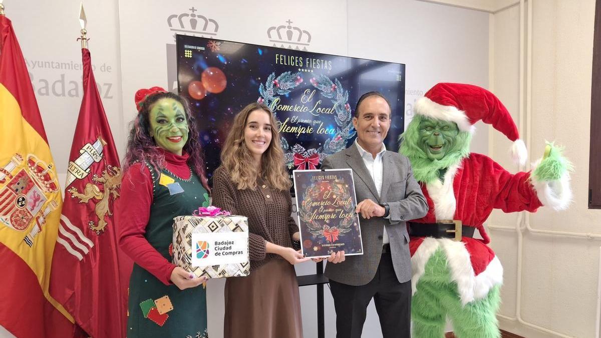 María Mangas, gerente de Comercio y Yayo Buzo, concejal del ayuntamiento, presentan la nueva campaña de comercio navideño junto a personajes de El Grinch.