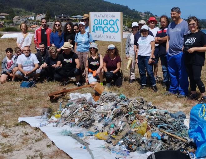 Los participantes y los restos de basura recogidos en la playa de Vilariño en la limpieza impulsada por la Plataforma Augas Limpas. /